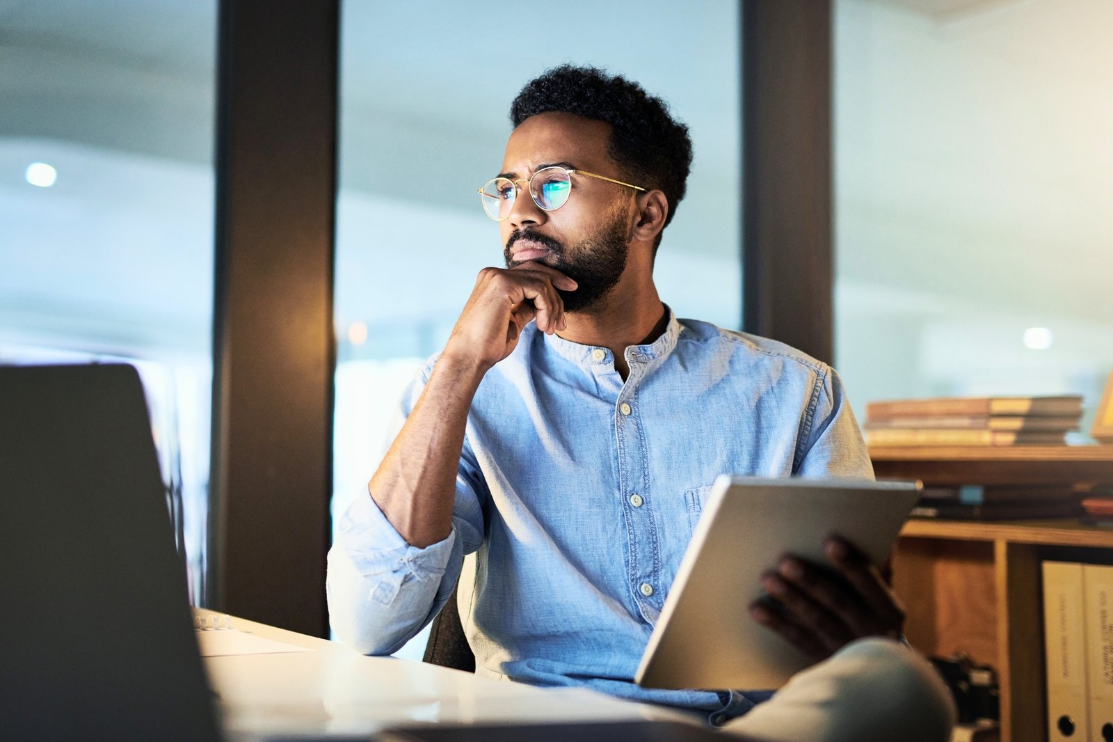 Financial Planning for Business Owners | Mass Financial Management Business owner reviewing financial information on a tablet while planning business growth and long-term financial goals.