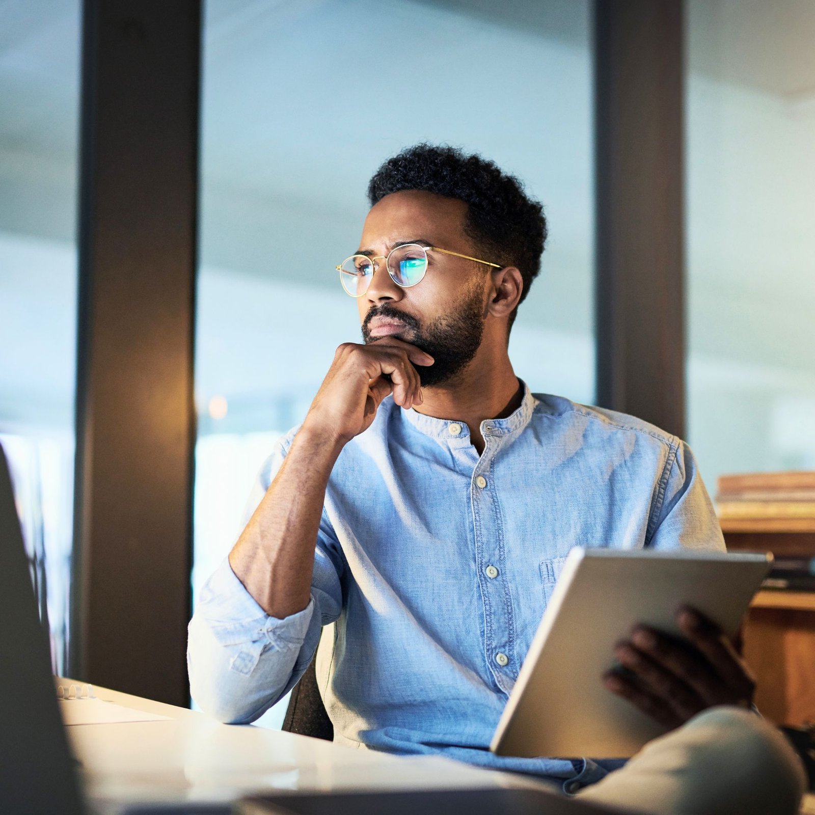 Financial Planning for Business Owners | Mass Financial Management Business owner reviewing financial information on a tablet while planning business growth and long-term financial goals.