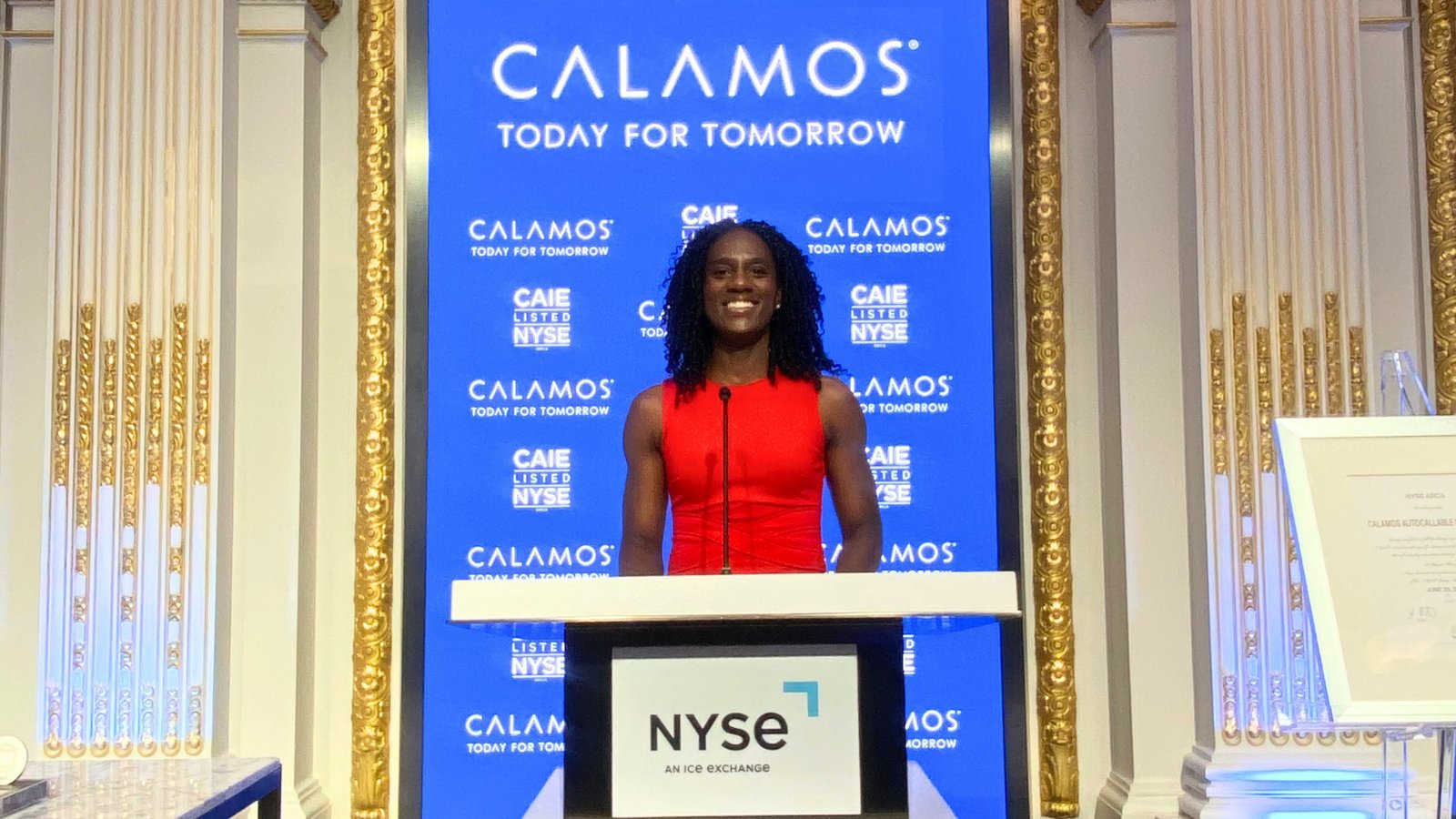 Christina Massalay speaking at the New York Stock Exchange (NYSE) during a financial industry event.