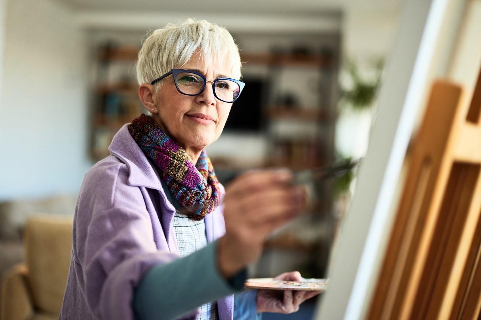 Retirement Planning | Mass Financial Management Retired woman enjoying painting during retirement after building long-term financial confidence through personalized financial planning.